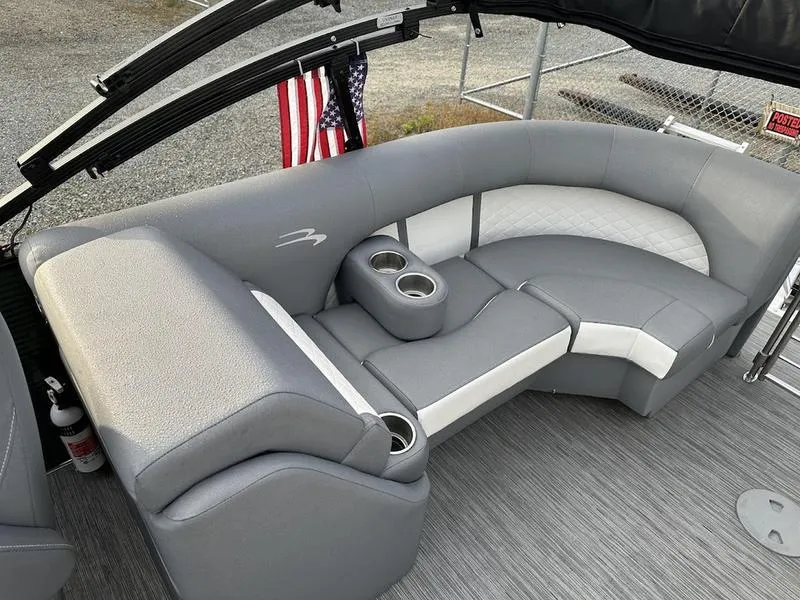 Slide: The Image of 2021 Bennington 22 LFB boat interior with gray seating and cup holders. - 9