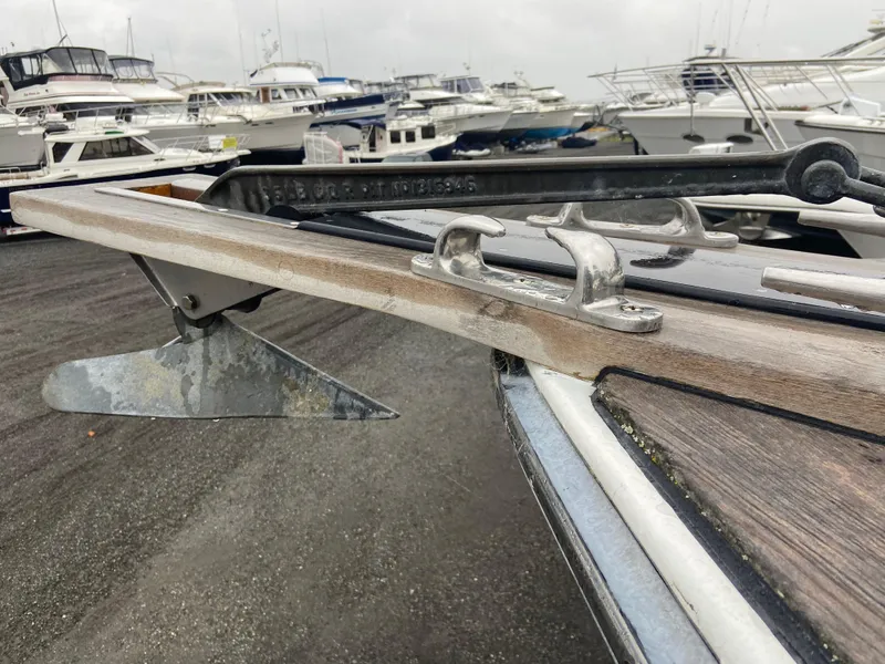 Slide: The Image of 2011 Sabre Custom Yachtfish anchor detail at marina with multiple yachts in background. - 13