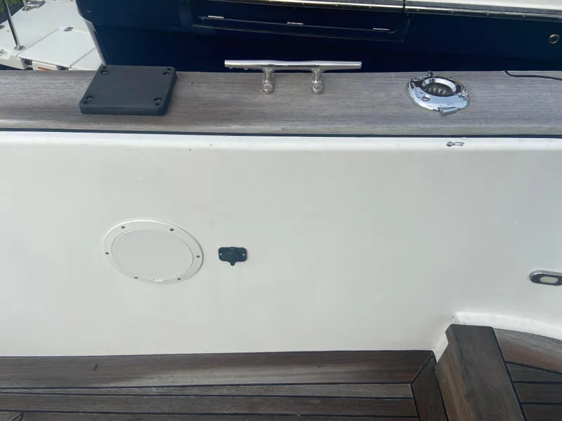 Slide: The Image of 2011 Sabre Custom Yachtfish deck with cleat and wood finish. - 17