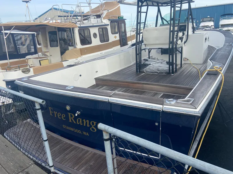 Slide: The Image of 2011 Sabre Custom Yachtfish docked, featuring spacious deck and elegant design. - 2