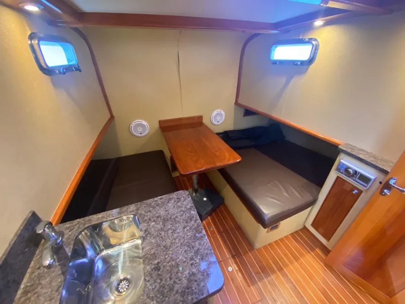 Slide: The Image of Interior of 2011 Sabre Custom Yachtfish with seating, table, and sink. - 20