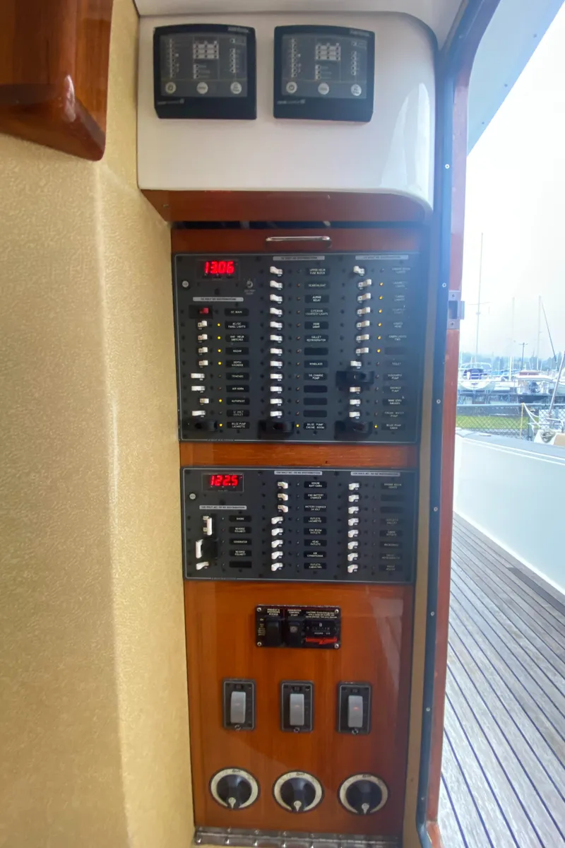 Slide: The Image of Electrical control panel on a 2011 Sabre Custom Yachtfish, featuring switches and gauges. - 22