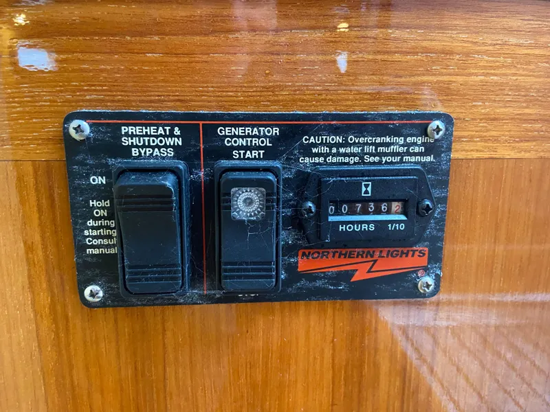 Slide: The Image of Control panel of a 2011 Sabre Custom Yachtfish with generator start and hour meter. - 23