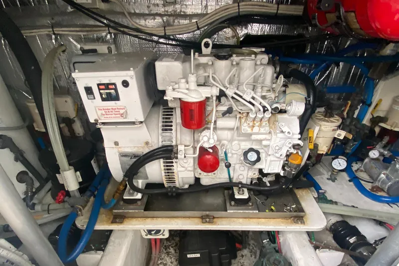 Slide: The Image of Engine room of 2011 Sabre Custom Yachtfish, featuring a well-maintained generator system. - 24