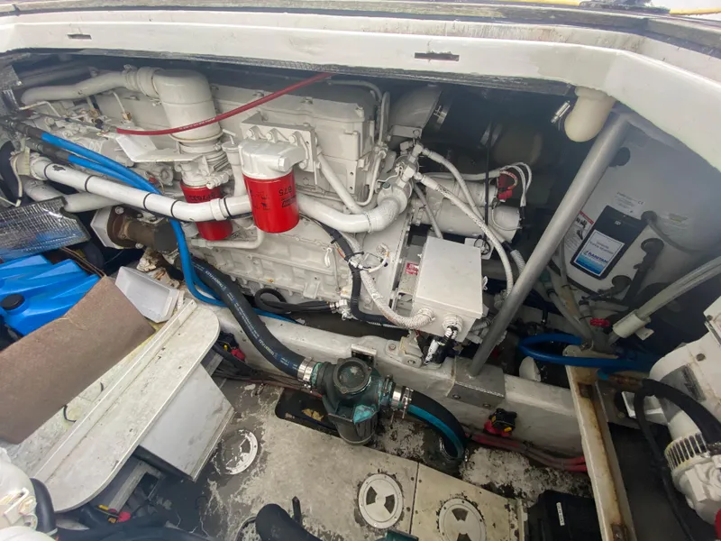 Slide: The Image of Engine compartment of a 2011 Sabre Custom Yachtfish, showcasing mechanical components and piping. - 25