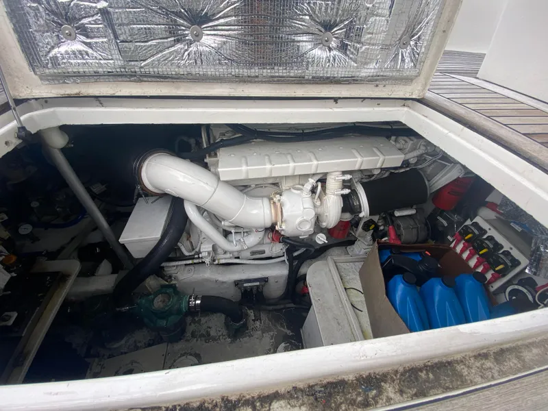 Slide: The Image of Engine compartment of a 2011 Sabre Custom Yachtfish, showcasing mechanical components and storage. - 26