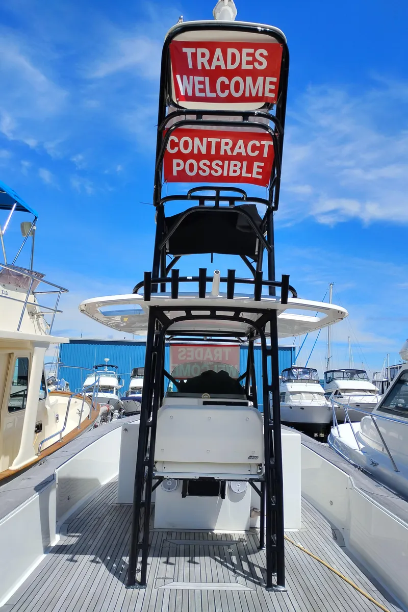 Slide: The Image of 2011 Sabre Custom Yachtfish with trade and contract options, docked under clear blue sky. - 27