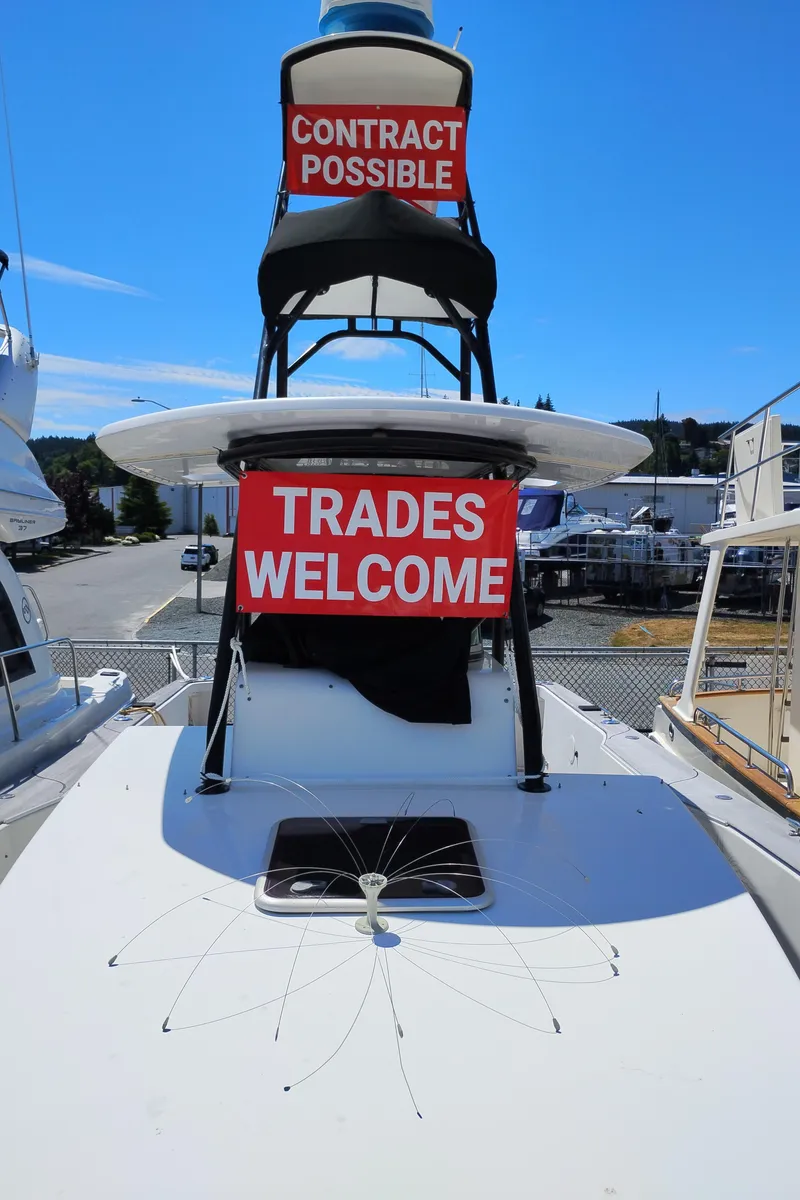 Slide: The Image of 2011 Sabre Custom Yachtfish with trade options, docked under clear blue sky. - 4