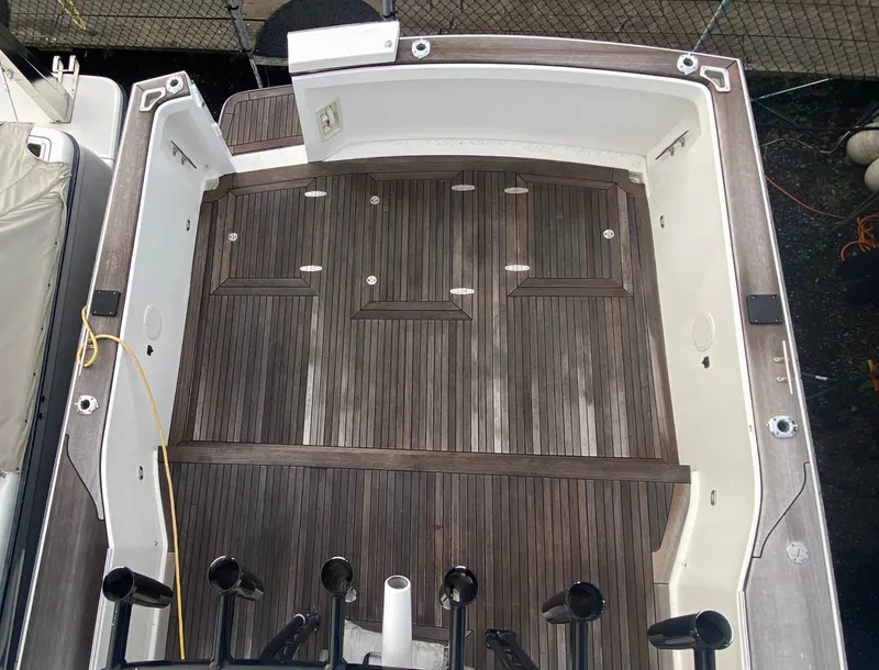 Slide: The Image of 2011 Sabre Custom Yachtfish deck with wood finish and rod holders. - 5