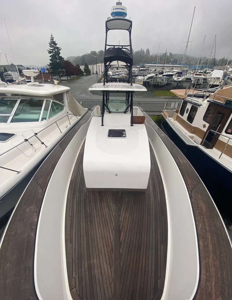 Slide: The Image of 2011 Sabre Custom Yachtfish with wooden deck, docked among other boats. - 6