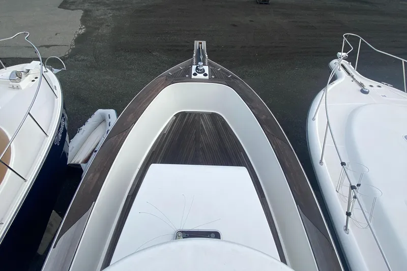 Slide: The Image of Bow view of 2011 Sabre Custom Yachtfish, docked between two boats. - 7