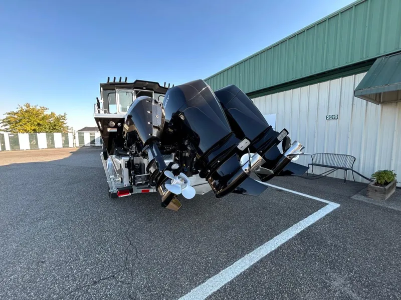 Slide: The Image of 2025 Thunder Jet Alexis Pro XL 26' boat with dual outboard motors in a parking lot. - 10