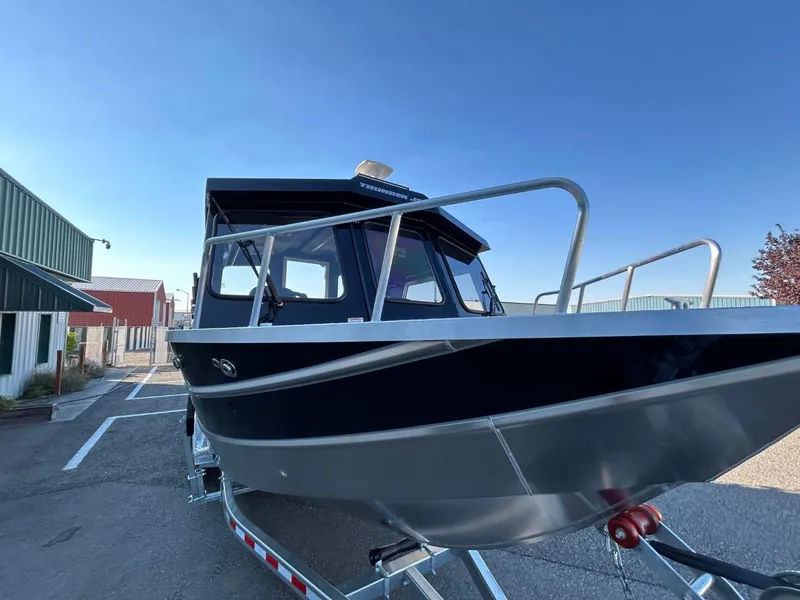 Slide: The Image of 2025 Thunder Jet Alexis Pro XL 26' boat on trailer, parked outdoors. - 12