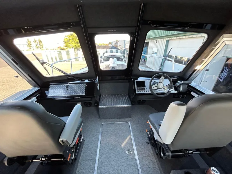 Slide: The Image of Interior of 2025 Thunder Jet Alexis Pro XL 26' boat cockpit with dual seats and controls. - 14