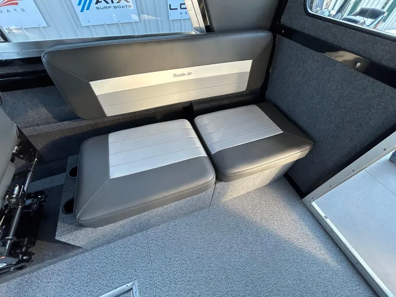 Slide: The Image of 2025 Thunder Jet Alexis Pro XL 26' interior seating with gray and white upholstery. - 16