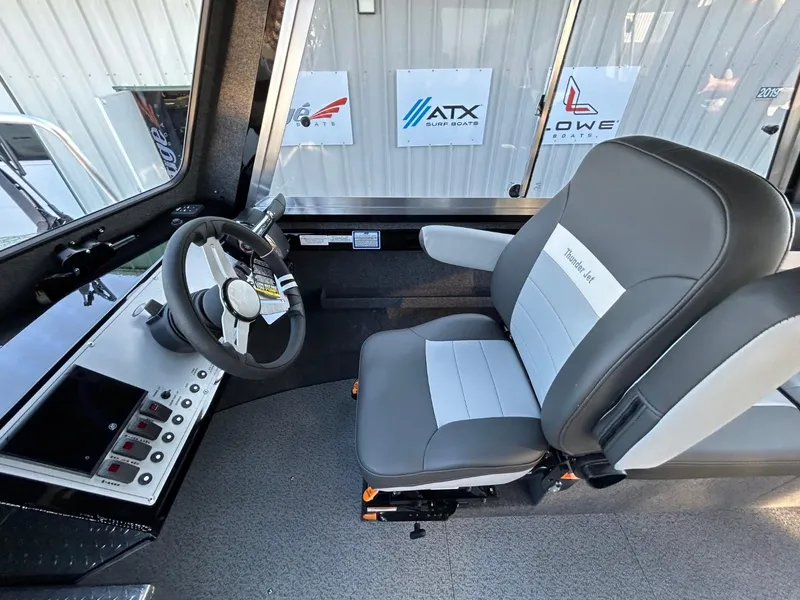 Slide: The Image of 2025 Thunder Jet Alexis Pro XL 26' boat interior with steering wheel and control panel. - 17