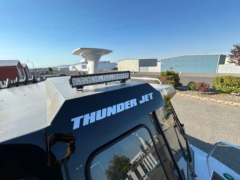 Slide: The Image of 2025 Thunder Jet Alexis Pro XL 26' boat with rooftop light bar in a marina setting. - 19