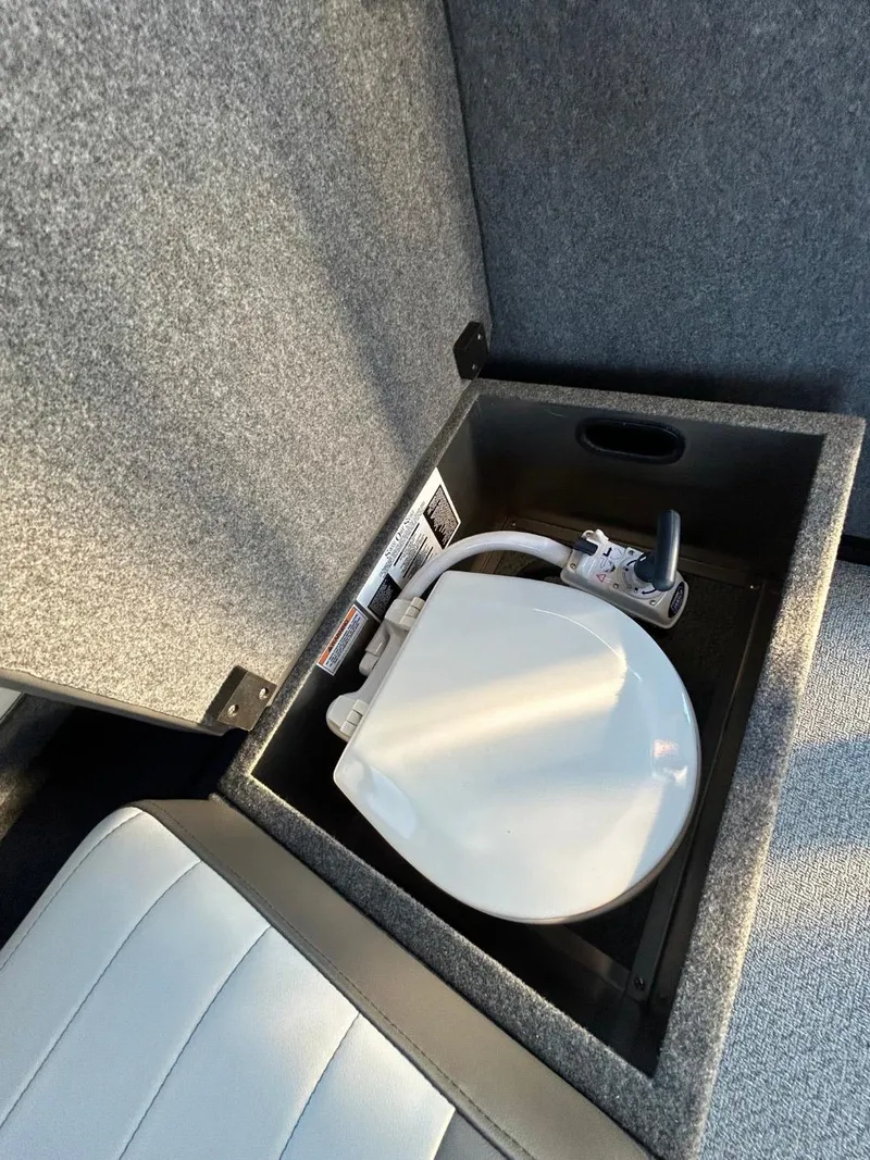Slide: The Image of 2025 Thunder Jet Alexis Pro XL 26' boat interior storage compartment with portable toilet. - 20