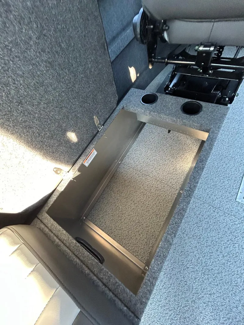 Slide: The Image of 2025 Thunder Jet Alexis Pro XL 26' interior storage compartment with cup holders. - 21