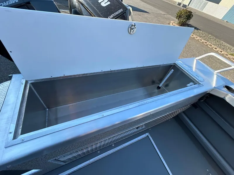 Slide: The Image of Open storage compartment on 2025 Thunder Jet Alexis Pro XL 26' boat. - 23