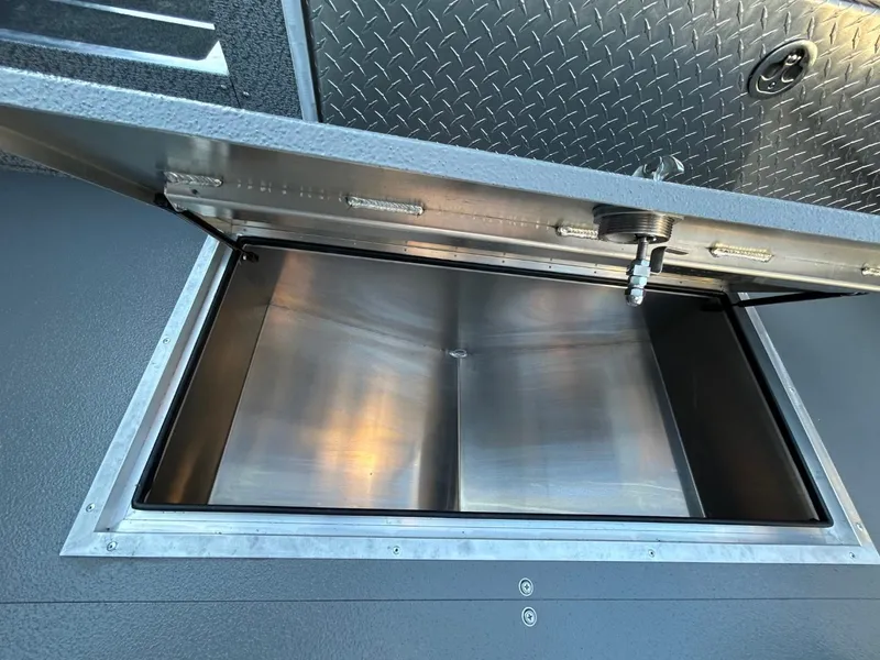 Slide: The Image of Open storage compartment in 2025 Thunder Jet Alexis Pro XL 26' boat. - 24