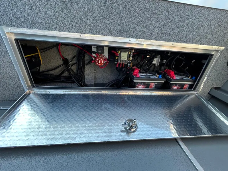 Slide: The Image of 2025 Thunder Jet Alexis Pro XL 26' battery compartment with wiring and components. - 25