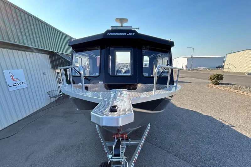 Slide: The Image of 2025 Thunder Jet Alexis Pro XL 26' boat on trailer, parked outside warehouse. - 28