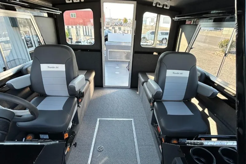 Slide: The Image of Interior of 2025 Thunder Jet Alexis Pro XL 26' boat with modern seating and controls. - 35