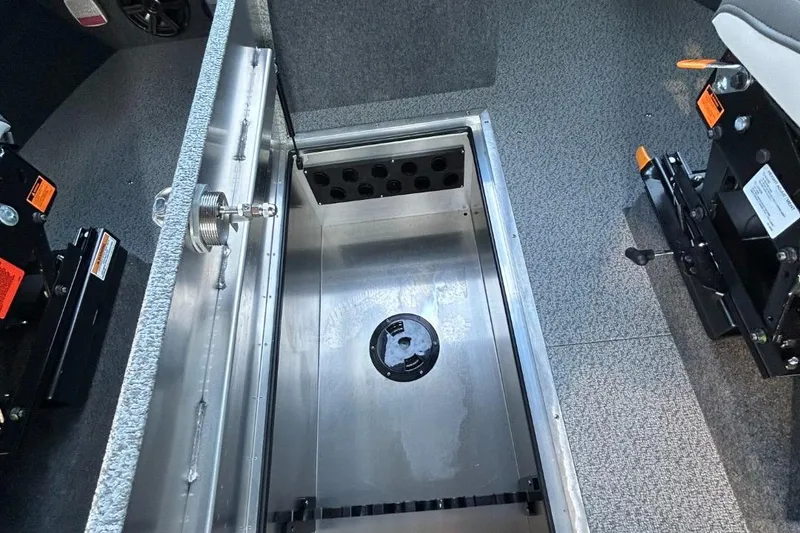 Slide: The Image of 2025 Thunder Jet Alexis Pro XL 26' interior storage compartment with secure latch and durable flooring. - 36