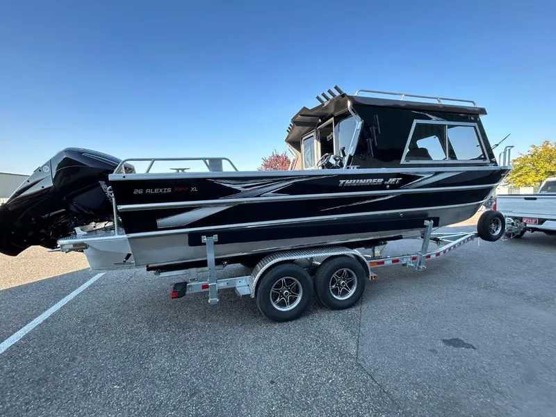 Slide: The Image of 2025 Thunder Jet Alexis Pro XL 26' boat on trailer, sleek black design. - 4