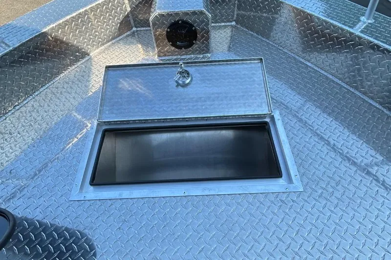 Slide: The Image of 2025 Thunder Jet Alexis Pro XL 26' boat with open storage compartment on diamond plate deck. - 41