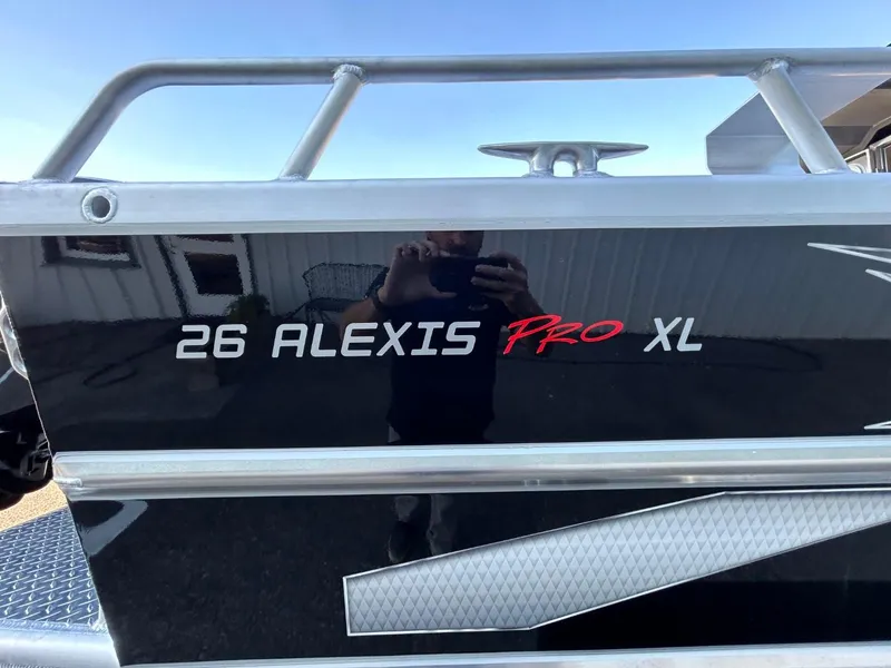 Slide: The Image of 2025 Thunder Jet Alexis Pro XL 26' boat model name on black surface. - 5