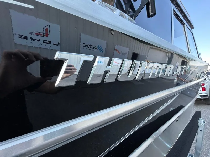 Slide: The Image of 2025 Thunder Jet Alexis Pro XL 26' boat, sleek design with reflective lettering. - 6