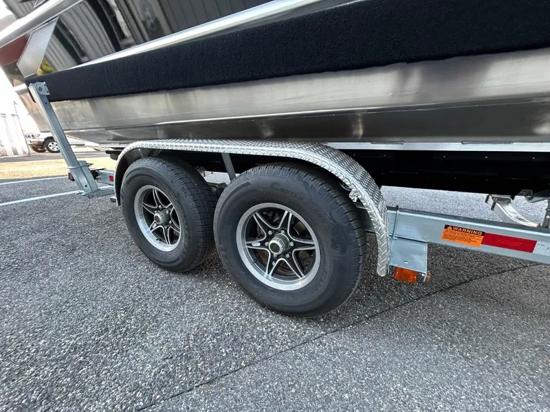Slide: The Image of 2025 Thunder Jet Alexis Pro XL 26' trailer with dual wheels on asphalt. - 7