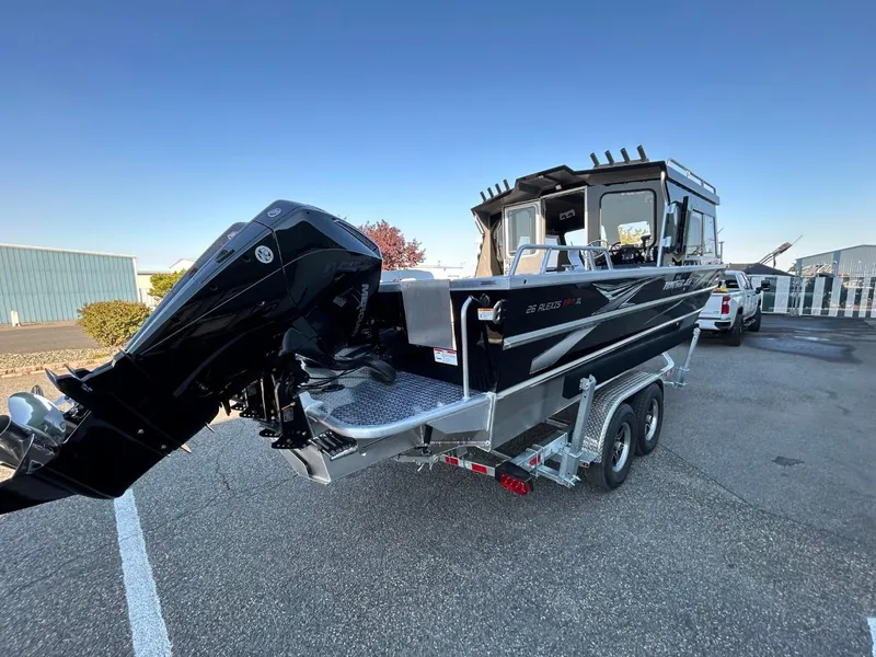 Slide: The Image of 2025 Thunder Jet Alexis Pro XL 26' boat with powerful outboard motor, parked on trailer. - 8