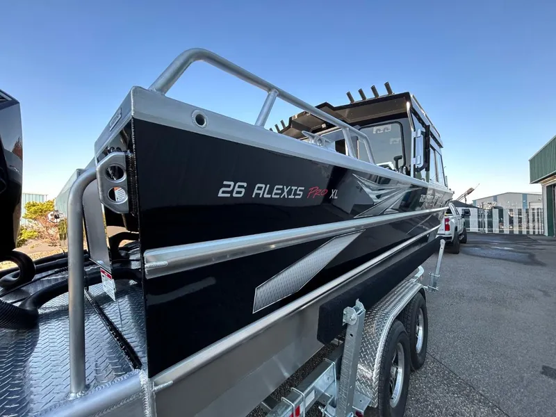 Slide: The Image of 2025 Thunder Jet Alexis Pro XL 26' boat on trailer, sleek black design. - 9