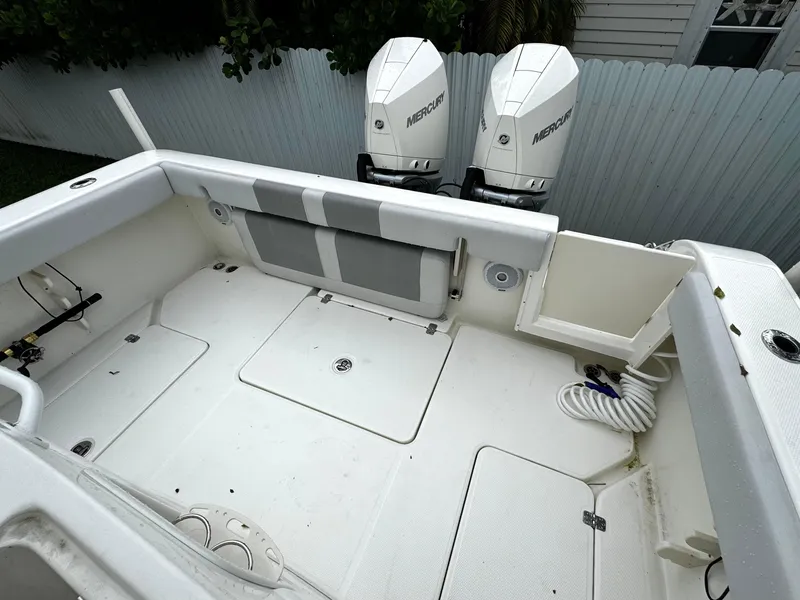 Slide: The Image of 2020 Mako 284 CC boat deck with dual Mercury outboard engines. - 12