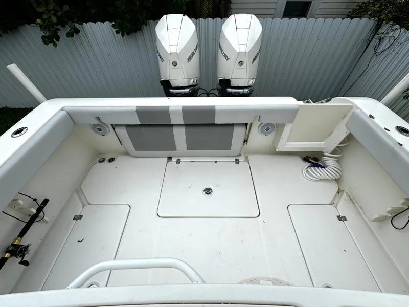 Slide: The Image of 2020 Mako 284 CC boat deck with twin Mercury outboard engines. - 13
