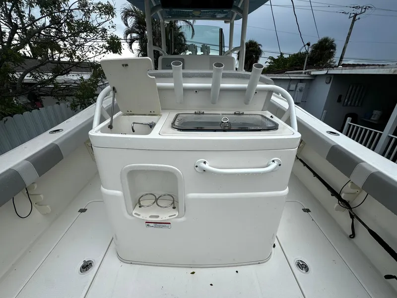 Slide: The Image of 2020 Mako 284 CC boat deck with fishing rod holders and storage. - 15