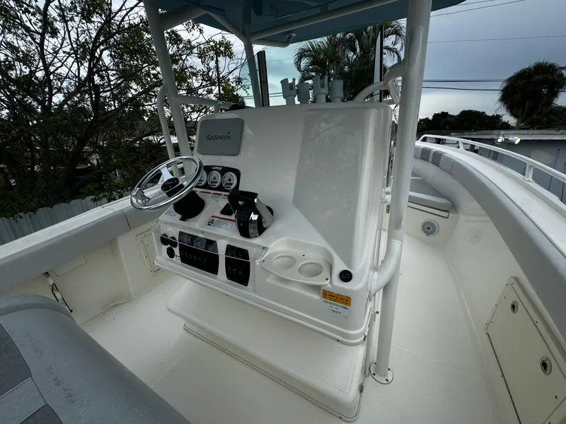Slide: The Image of 2020 Mako 284 CC boat console with steering wheel and navigation equipment. - 17