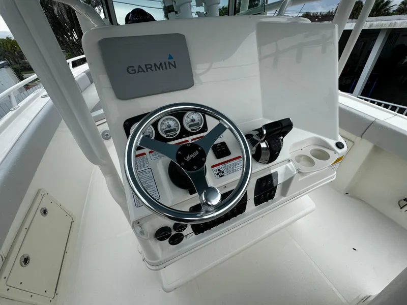 Slide: The Image of Mako 284 CC 2020 boat console with Garmin navigation system and steering wheel. - 18