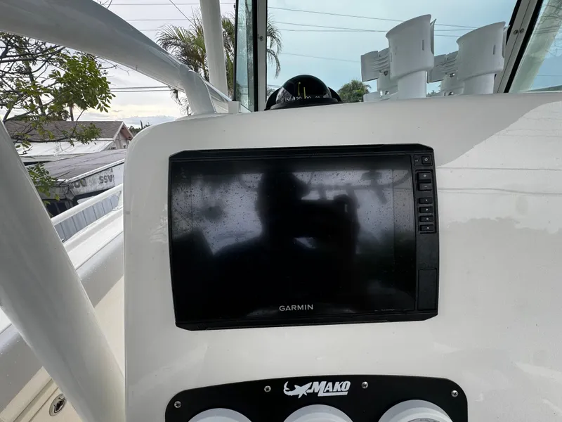 Slide: The Image of Garmin display on 2020 Mako 284 CC boat dashboard, featuring rod holders. - 20