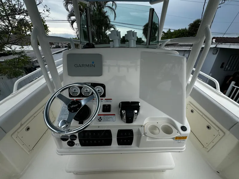 Slide: The Image of 2020 Mako 284 CC boat console with Garmin navigation system and steering wheel. - 22