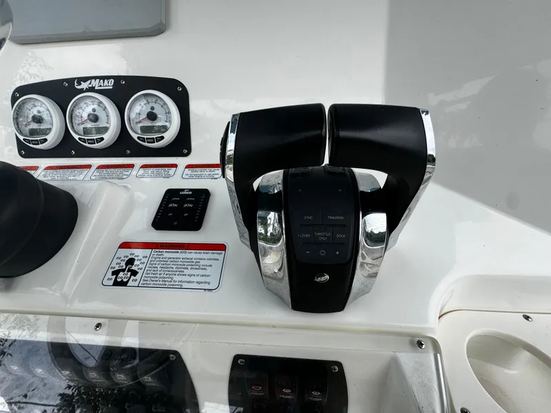 Slide: The Image of Control panel of 2020 Mako 284 CC boat with throttle and gauges. - 23