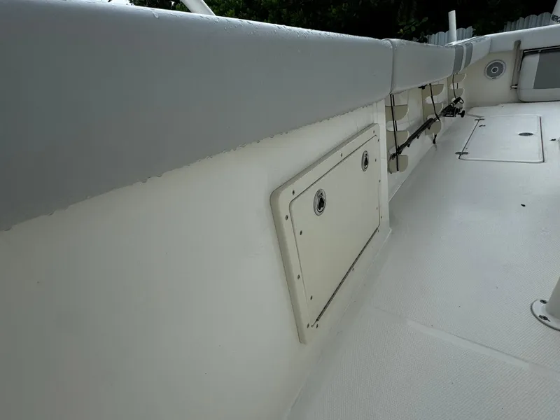 Slide: The Image of 2020 Mako 284 CC boat interior, featuring storage compartment and clean deck design. - 26