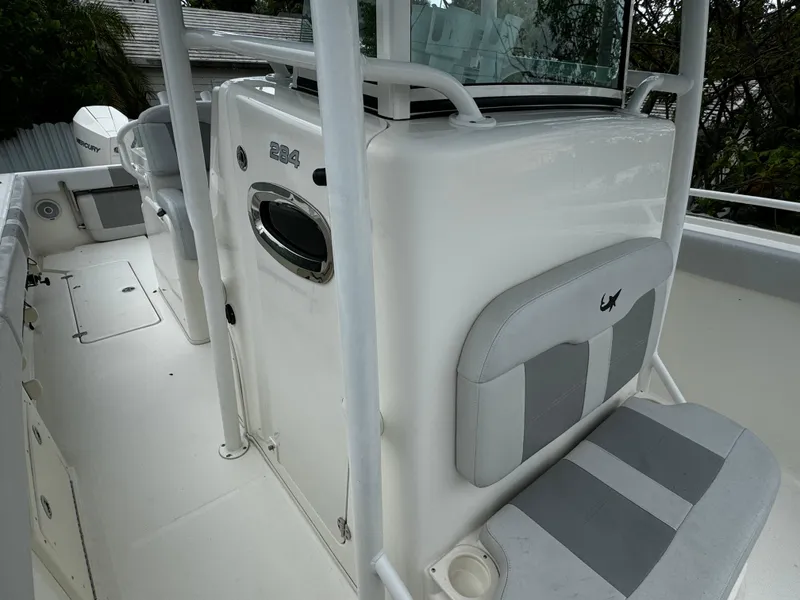 Slide: The Image of 2020 Mako 284 CC boat interior with seating and console details. - 27