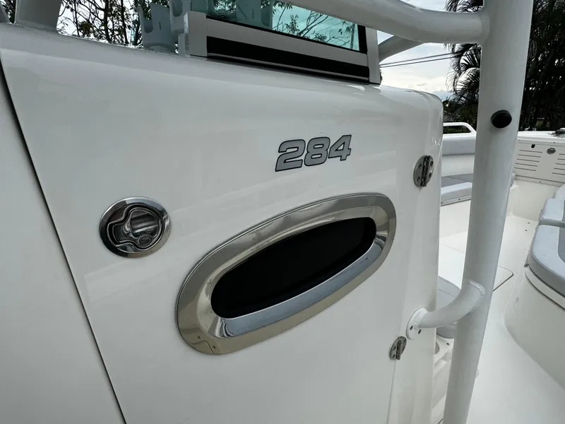 Slide: The Image of 2020 Mako 284 CC boat detail with sleek design and chrome accents. - 29