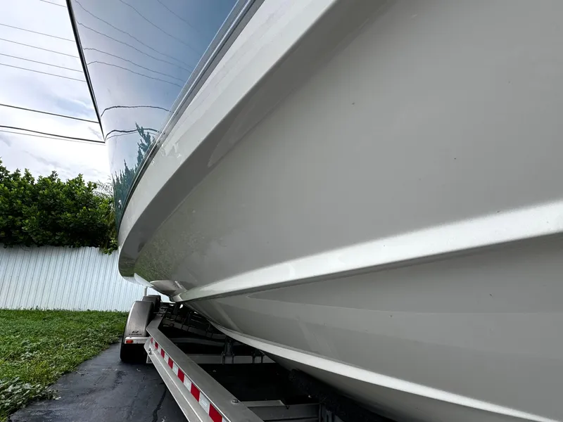 Slide: The Image of 2020 Mako 284 CC boat on trailer, side view. - 3