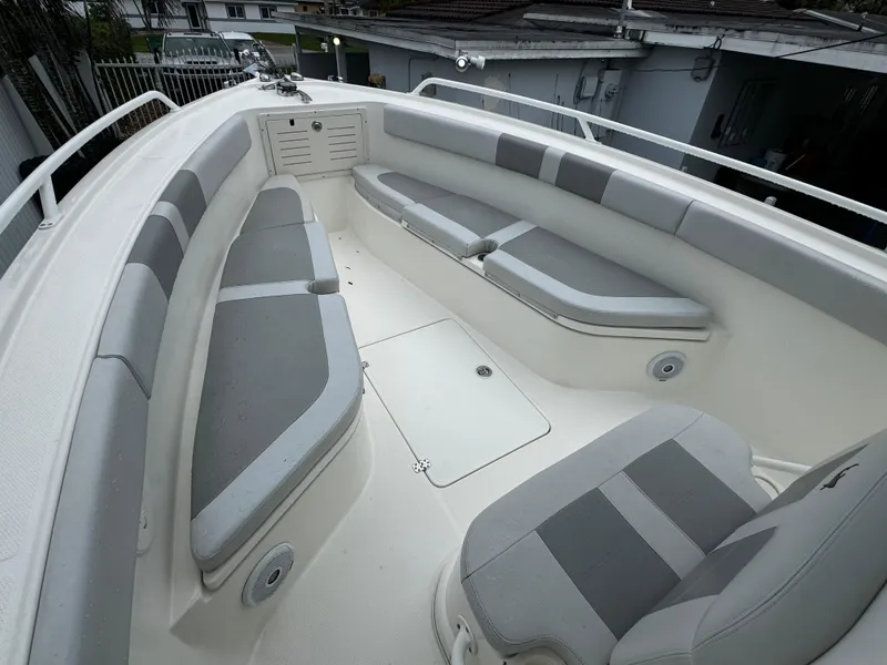 Slide: The Image of 2020 Mako 284 CC boat interior with gray and white seating. - 32