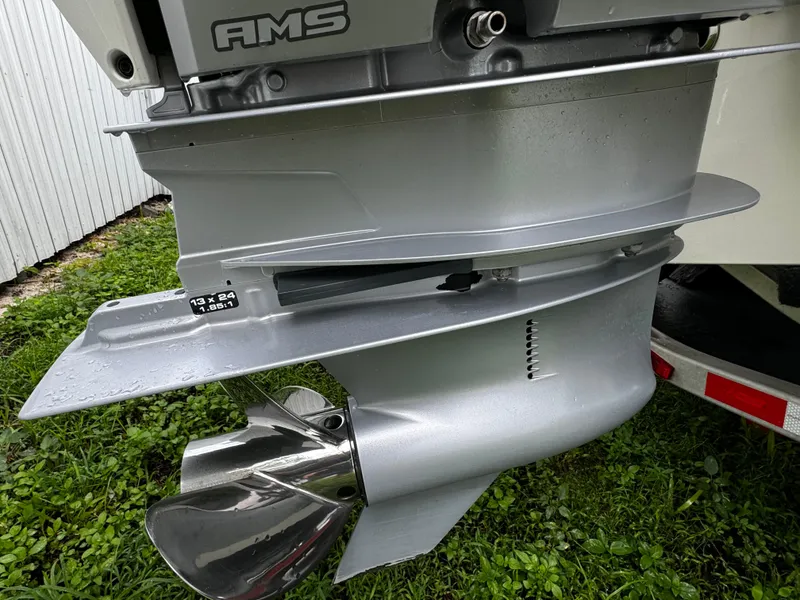 Slide: The Image of Close-up of a 2020 Mako 284 CC boat motor propeller on grass. - 6
